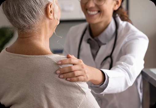 Doctor reassuring a senior patient during a clinic consultation